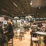 A group of tech professionals networking at a conference, engaging in discussions and exchanging ideas.