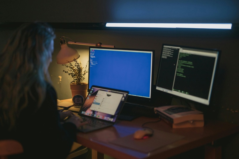 Person coding on laptop with icons of code, learning, and progress around, symbolizing daily improvement in programming skills