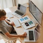 Focused coder smiling while working on a project at their desk
