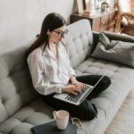 Female developer working remotely on a laptop from home, representing remote coding jobs in 2025