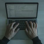 Person coding on a laptop while learning algorithms and data structures